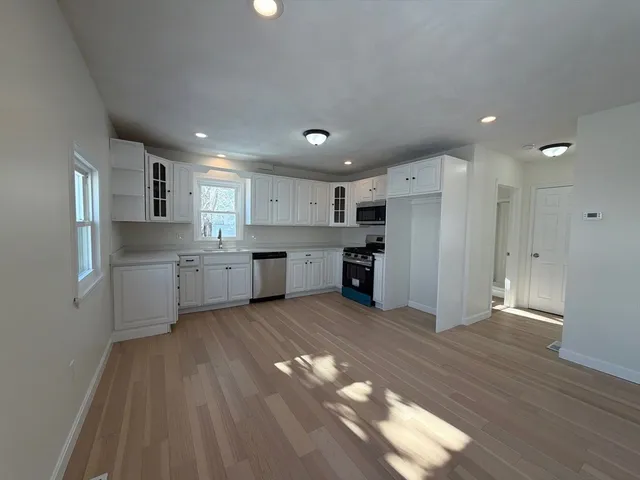 a bathroom with a tub sink and mirror