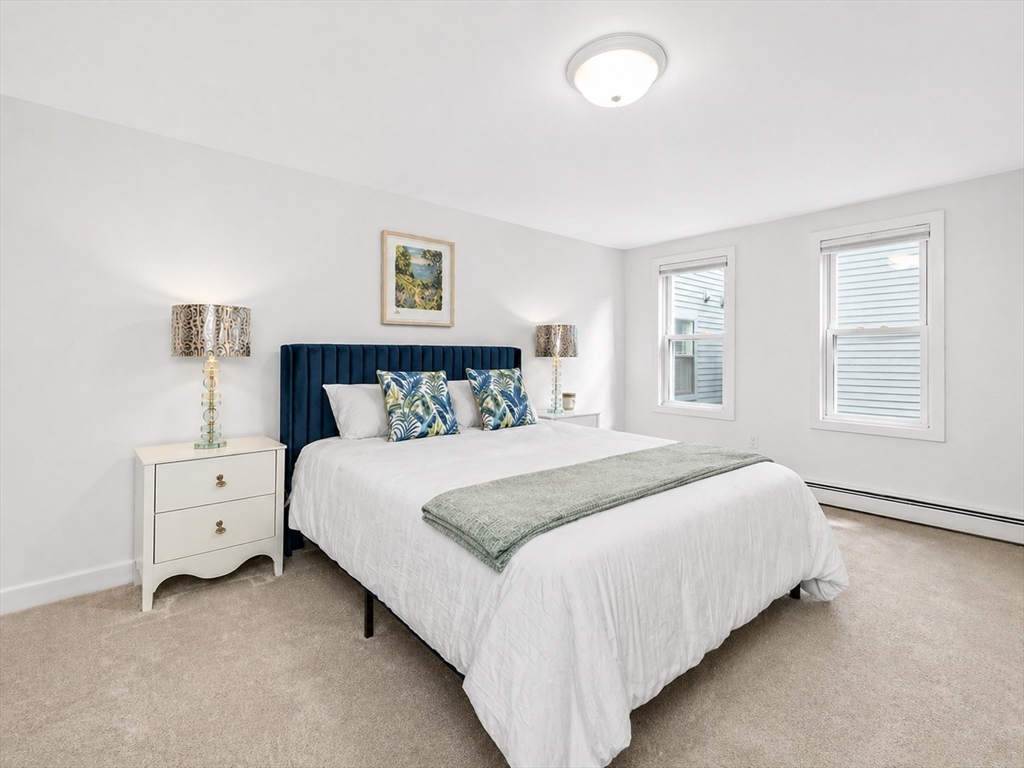 18 R Polk Street Boston, MA 02129 - Photo 12 of 19 a bedroom with a bed and a night stand