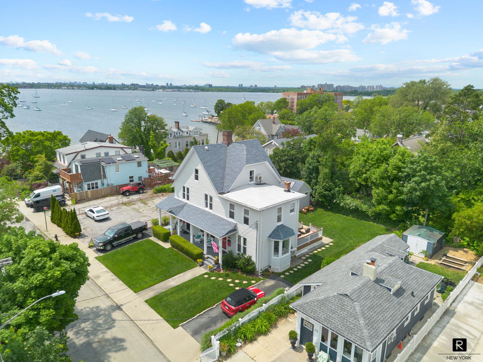 an aerial view of a house with a garden and lake view