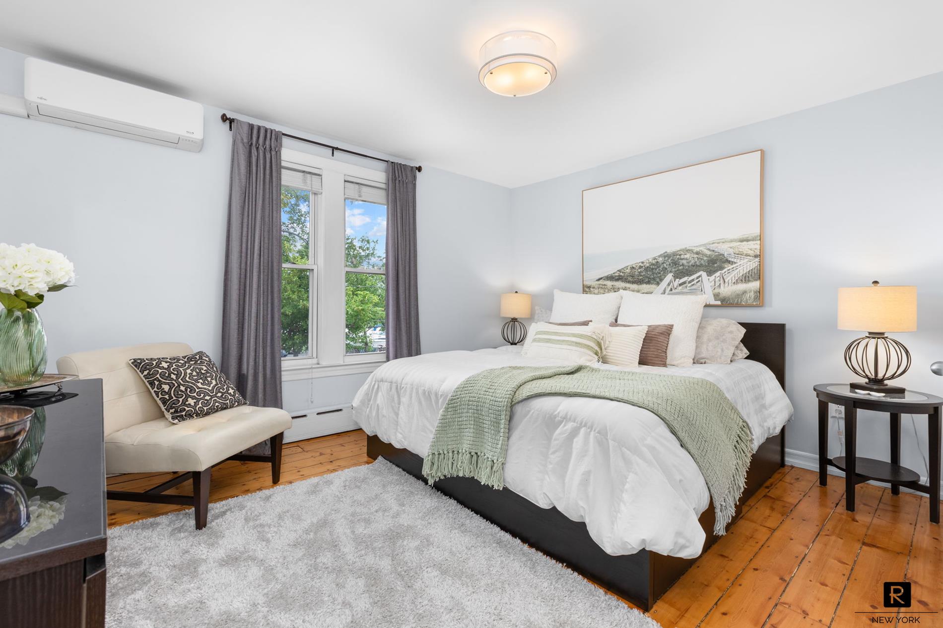 111 Rochelle Street Bronx, NY 10464 - Photo 7 of 28 a spacious bedroom with a bed and a couch