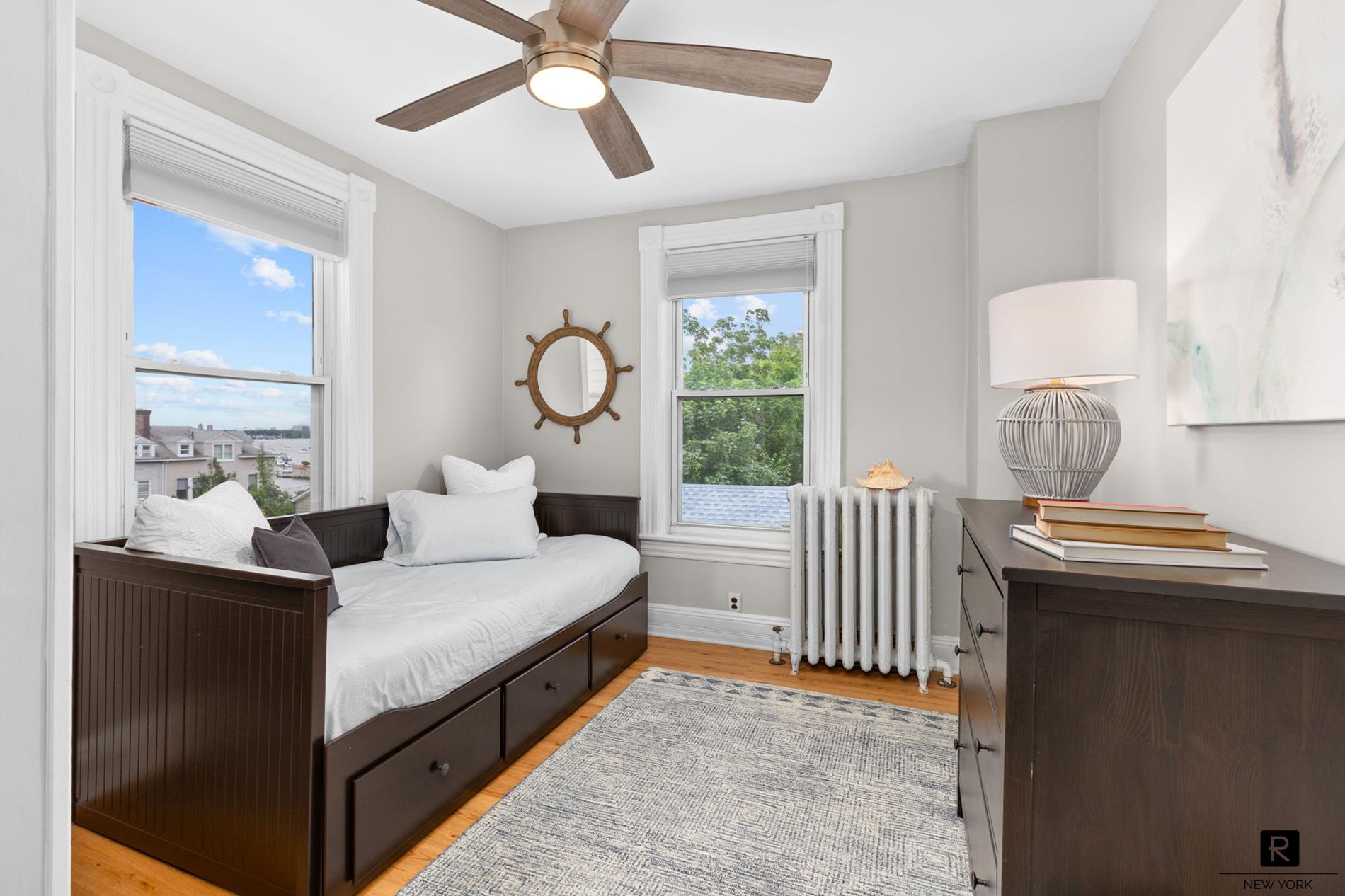 111 Rochelle Street Bronx, NY 10464 - Photo 19 of 28 a bedroom with a bed and a chandelier