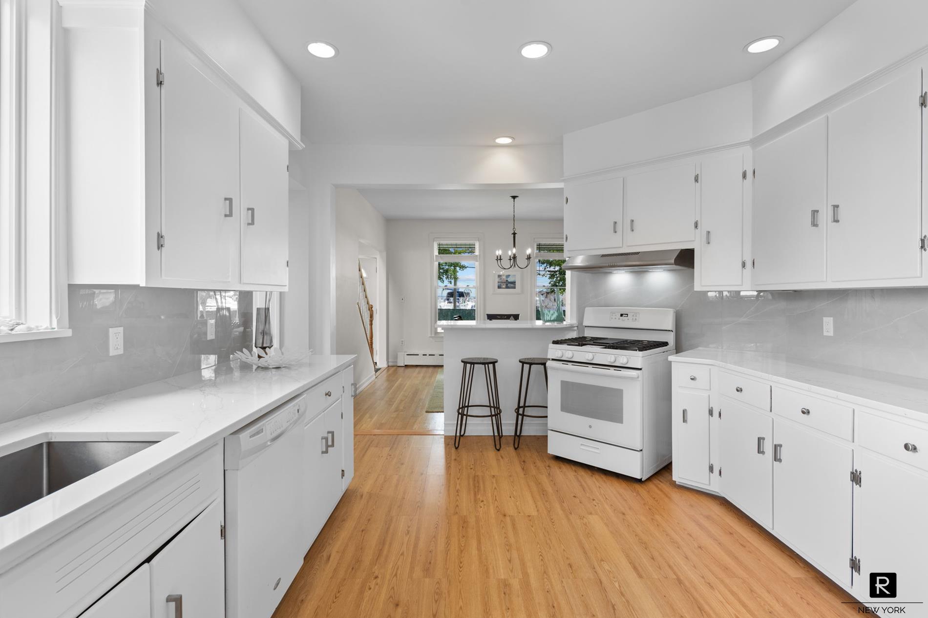 111 Rochelle Street Bronx, NY 10464 - Photo 6 of 28 a kitchen with granite countertop a sink cabinets and stainless steel appliances