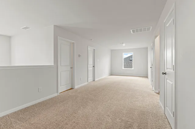 a view of an empty room and closet area