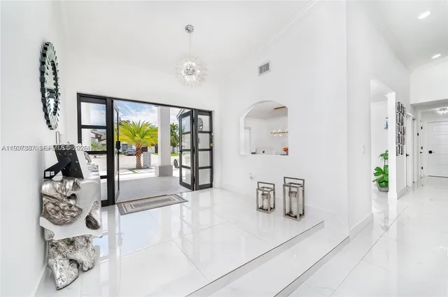 a large kitchen with stainless steel appliances a refrigerator stove microwave and sink