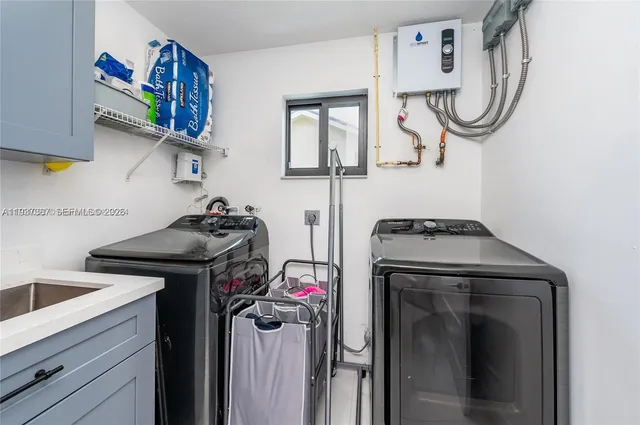 a kitchen with granite countertop a sink stainless steel appliances and cabinets