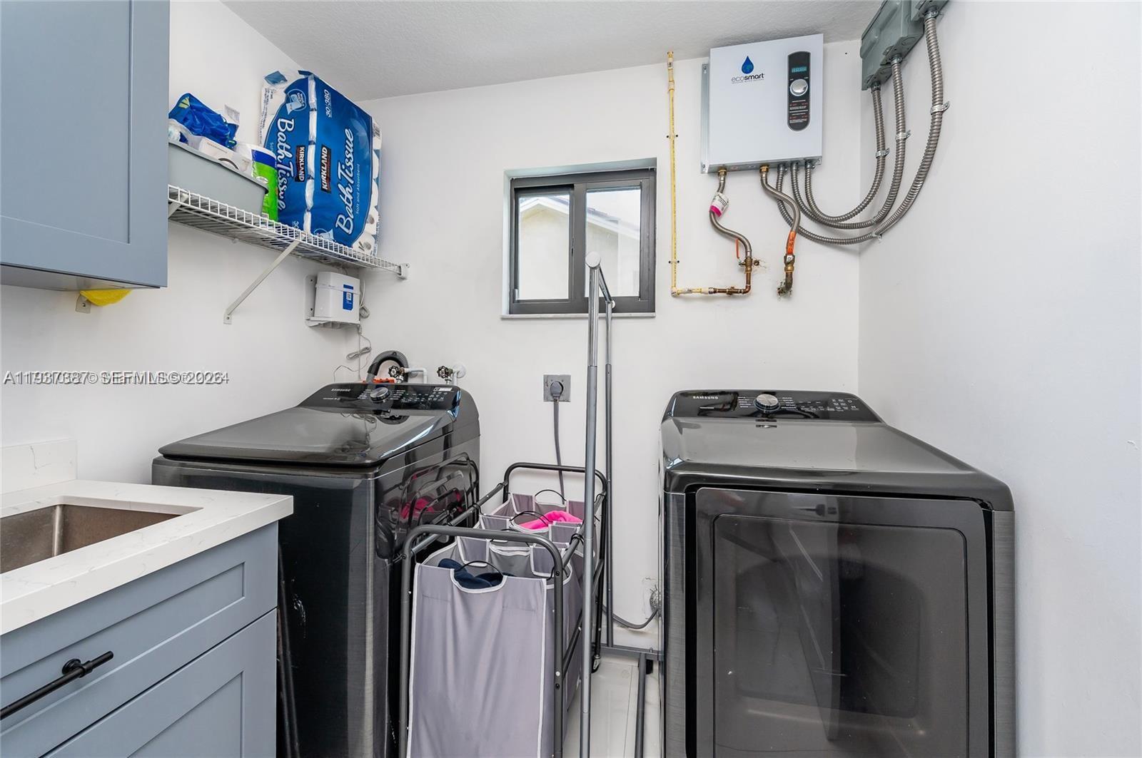 9701 Southwest 56th Terrace Miami, FL 33173 - Photo 14 of 48 a utility room with dryer and washer