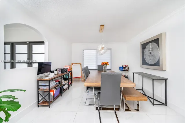 a large kitchen with dining table and chairs