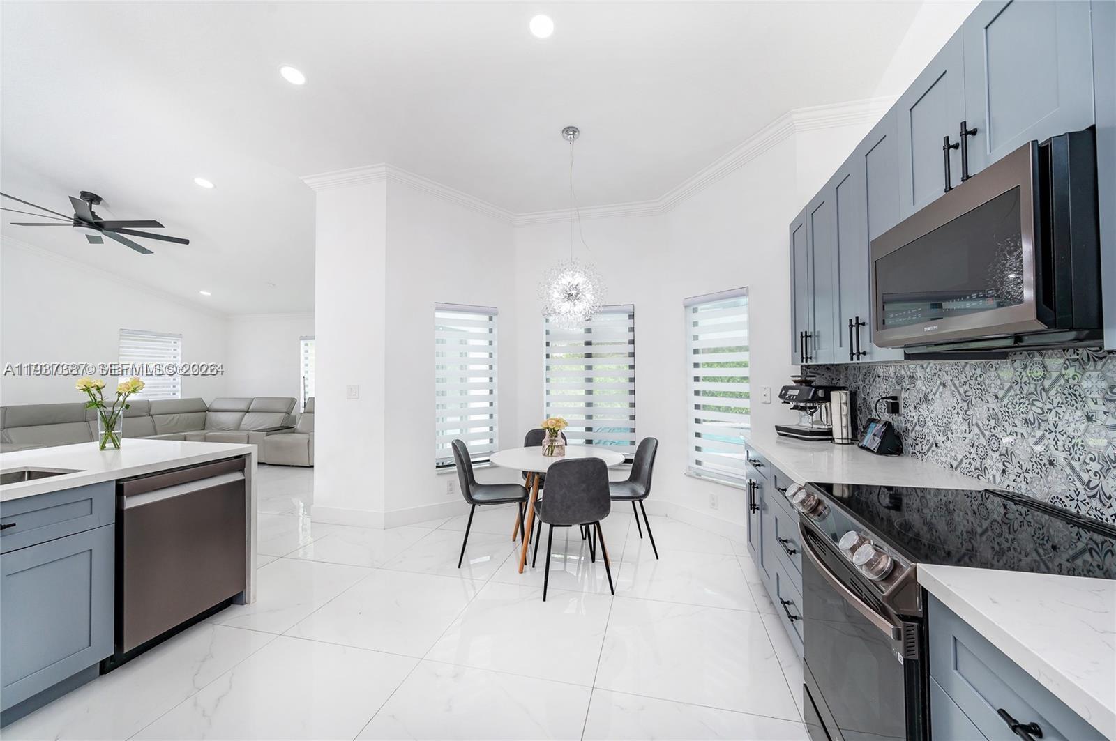 9701 Southwest 56th Terrace Miami, FL 33173 - Photo 18 of 48 a kitchen with granite countertop a sink stainless steel appliances and cabinets