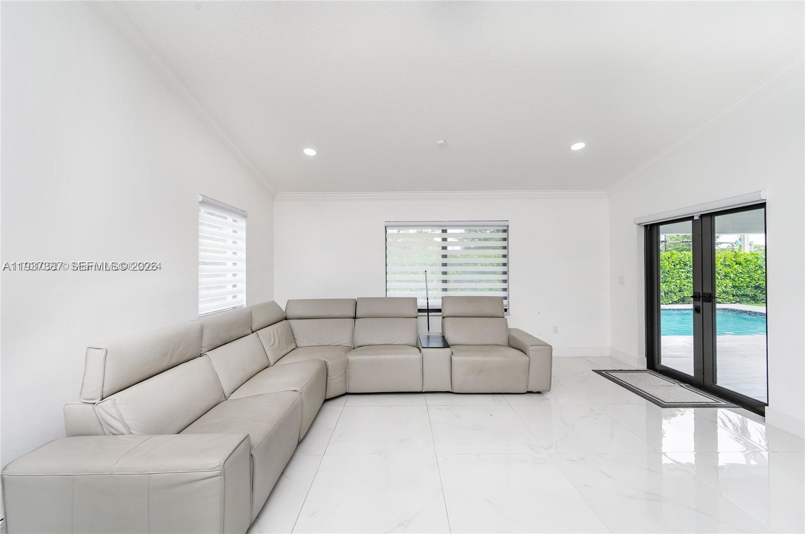9701 Southwest 56th Terrace Miami, FL 33173 - Photo 20 of 48 a living room with furniture and a large window