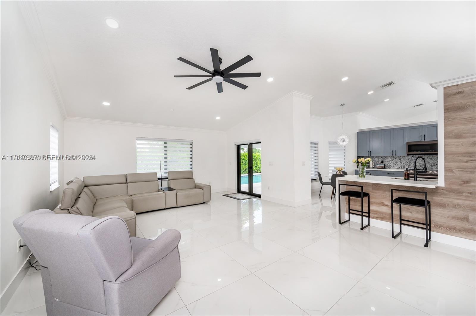 9701 Southwest 56th Terrace Miami, FL 33173 - Photo 21 of 48 a living room with furniture and a large window