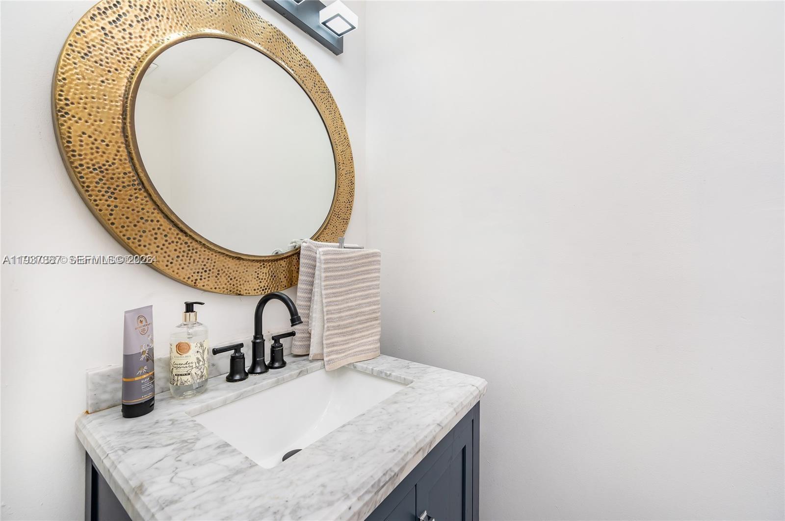 9701 Southwest 56th Terrace Miami, FL 33173 - Photo 22 of 48 a bathroom with a sink and a mirror