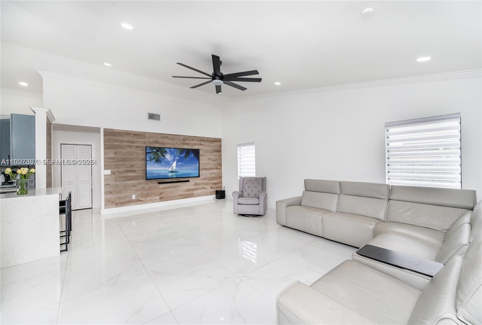 9701 Southwest 56th Terrace Miami, FL 33173 - Photo 24 of 48 a living room with furniture and a ceiling fan
