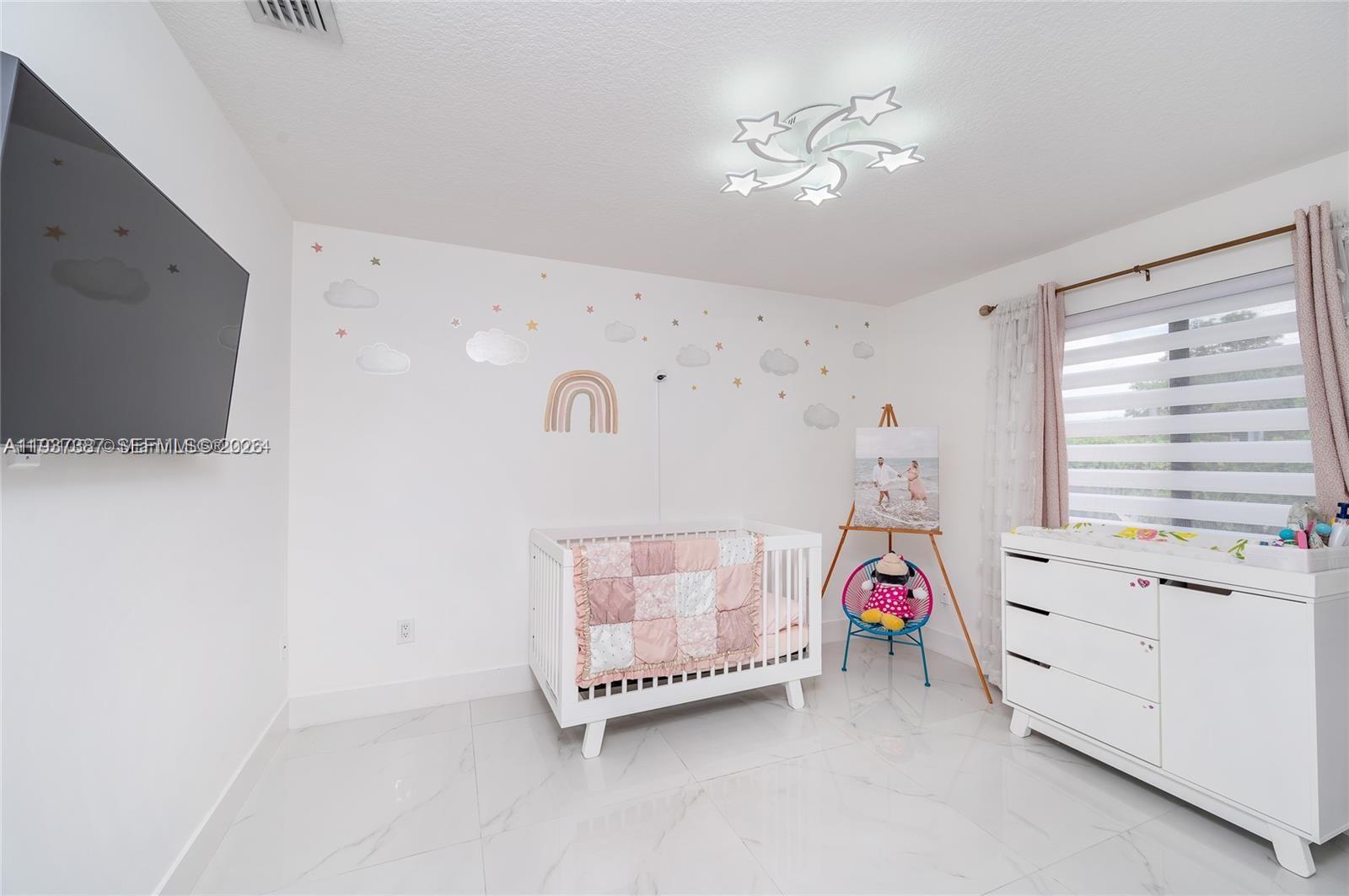 9701 Southwest 56th Terrace Miami, FL 33173 - Photo 28 of 48 a room with a bed and a chandelier