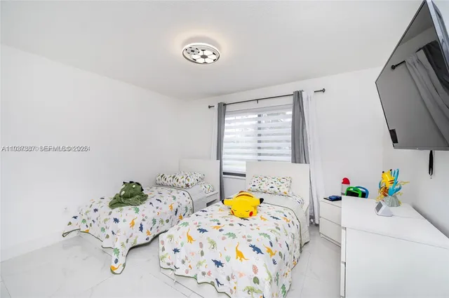 a bedroom with furniture and a window