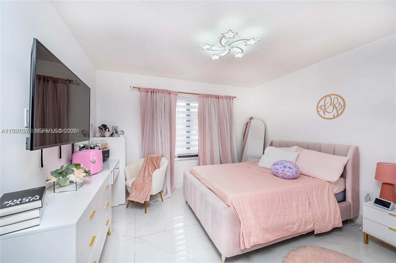 9701 Southwest 56th Terrace Miami, FL 33173 - Photo 30 of 48 a bedroom with a bed and a chandelier