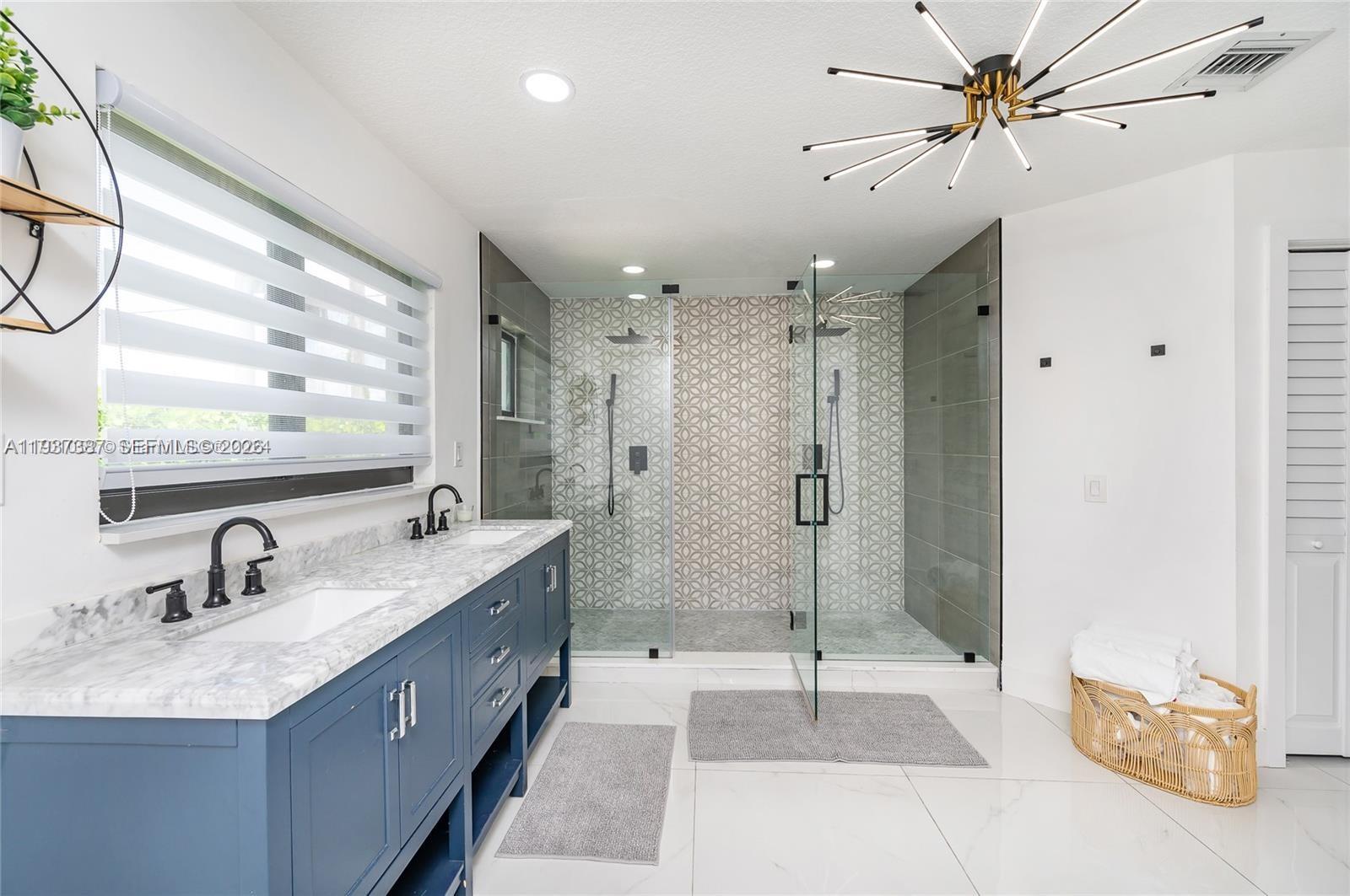 9701 Southwest 56th Terrace Miami, FL 33173 - Photo 34 of 48 a bathroom with a double vanity sink mirror and shower