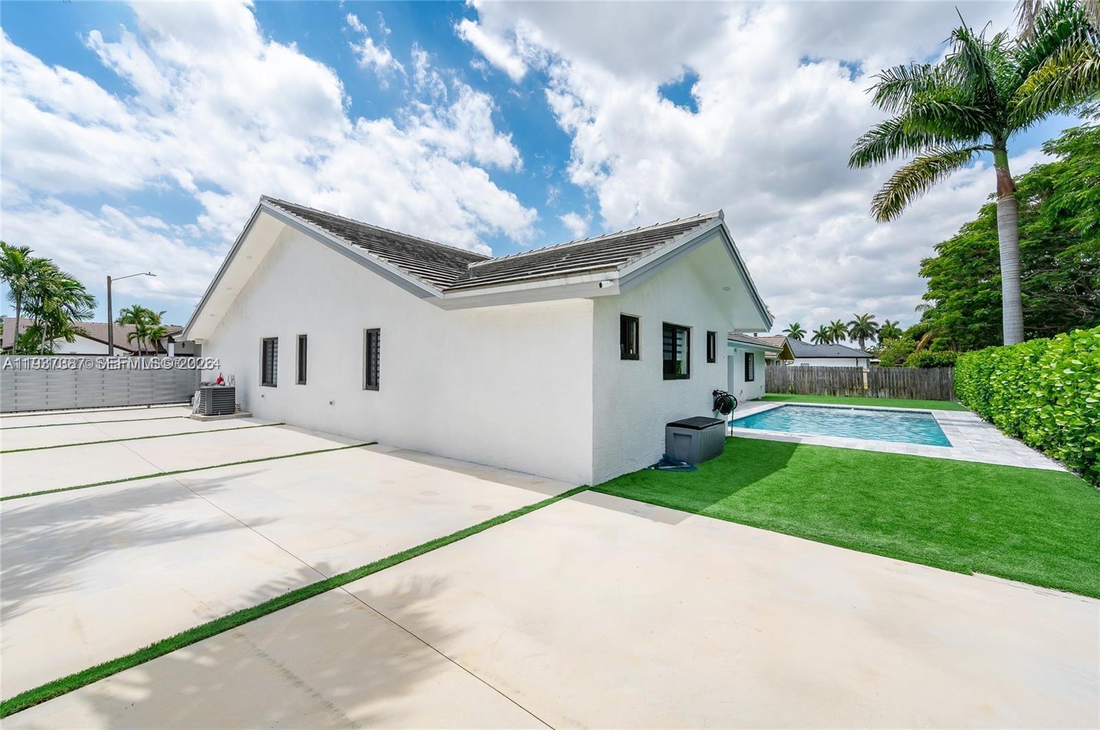 9701 Southwest 56th Terrace Miami, FL 33173 - Photo 5 of 48 a front view of a house with yard and green space