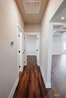 a view of a room with wooden floor
