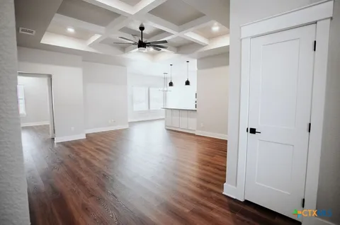 a view of an empty room and wooden floor