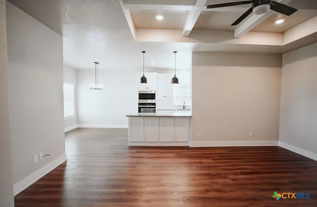 a view of kitchen and wooden floor