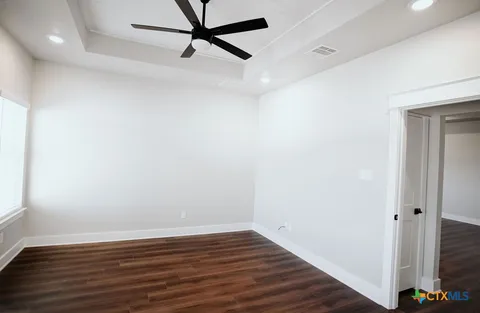 a view of a room with wooden floor and white walls