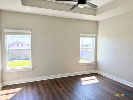 an empty room with wooden floor and a window