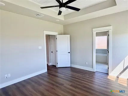 an empty room with wooden floor and door