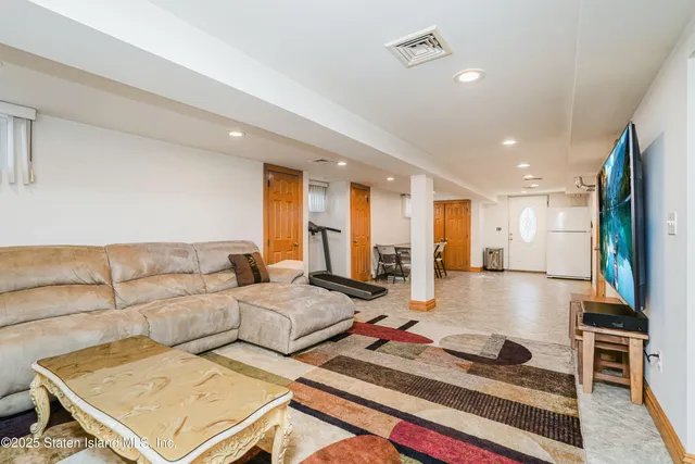 a living room with couches and a flat screen tv