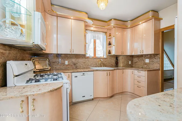 a kitchen with stainless steel appliances granite countertop a sink stove and cabinets