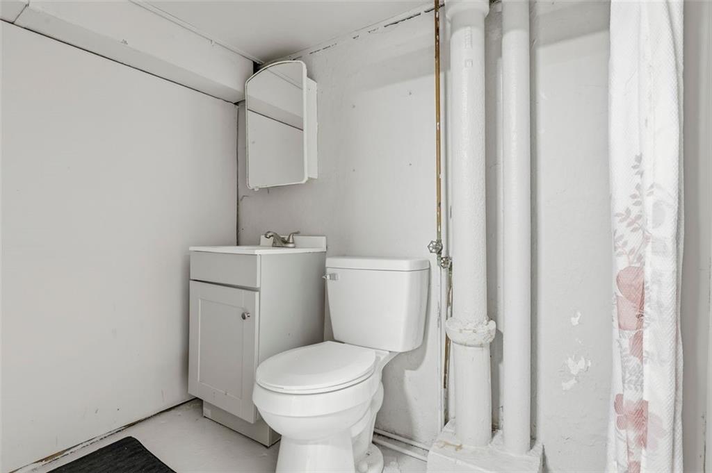 238 Provost Road Pittsburgh, PA 15227 - Photo 27 of 34 a white toilet sitting next to a bathroom sink