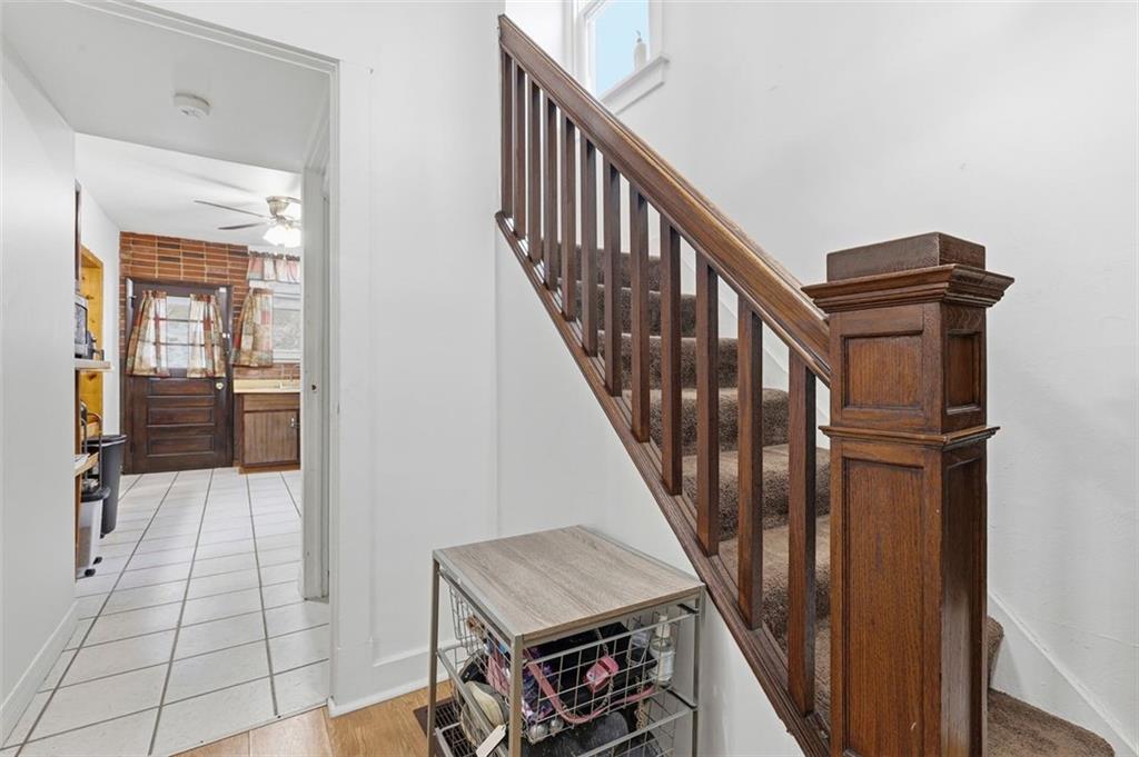238 Provost Road Pittsburgh, PA 15227 - Photo 6 of 34 a view of staircase with lots of frames on wall and a window