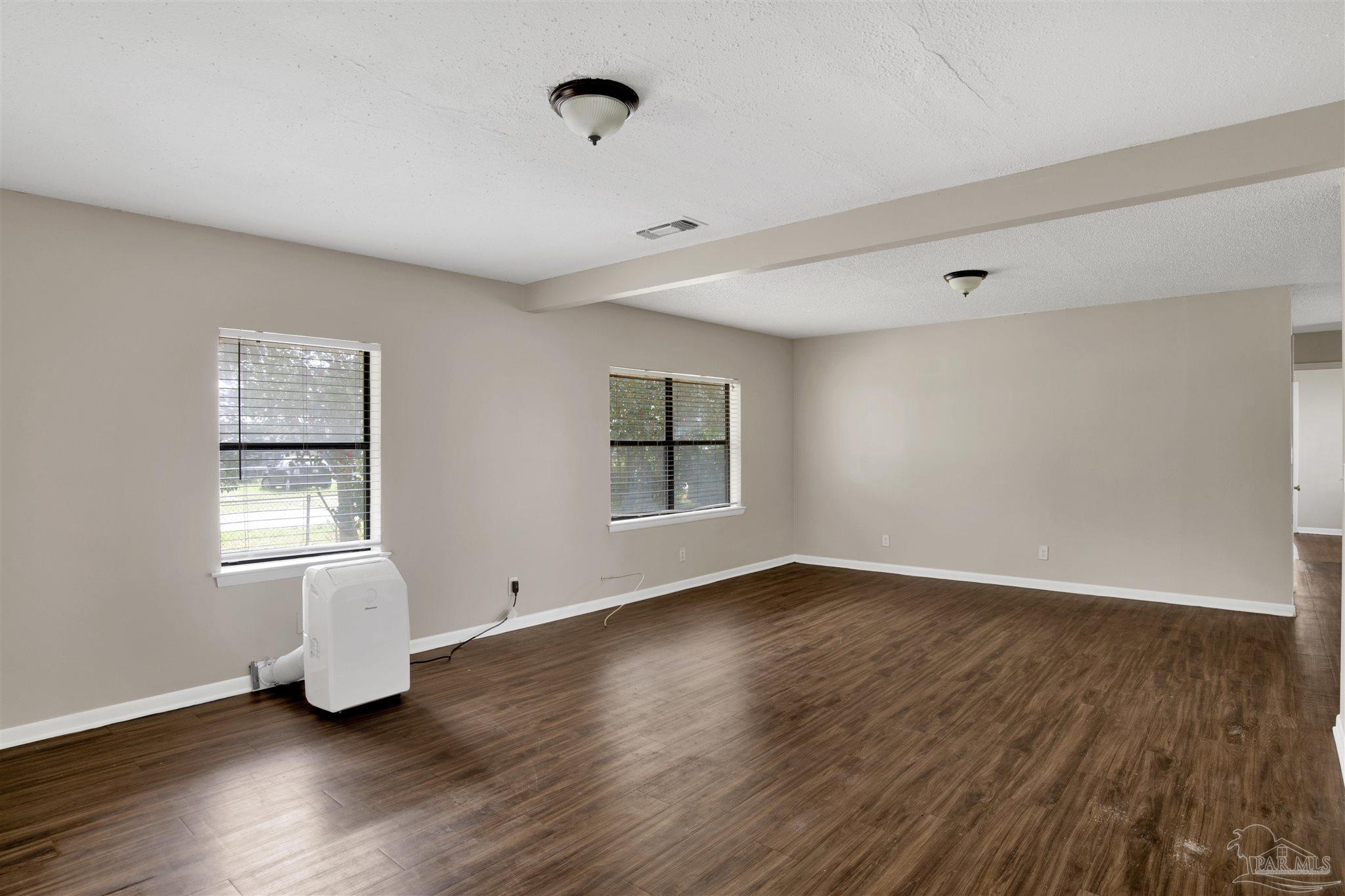 2802 West Gonzalez Street Pensacola, FL 32505 - Photo 11 of 24 an empty room with wooden floor and windows
