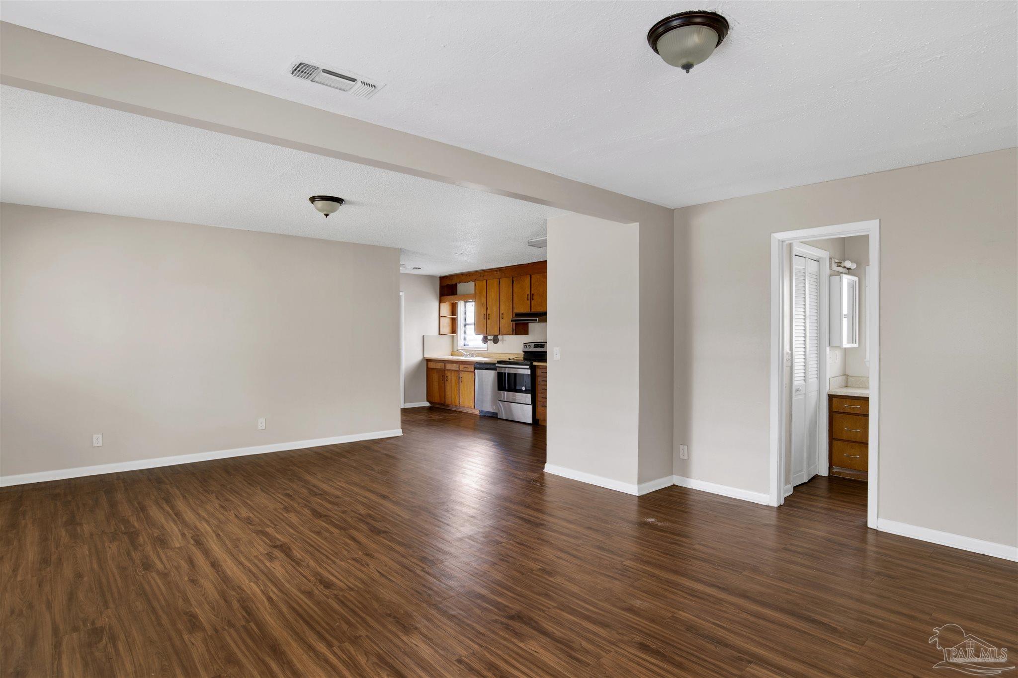 2802 West Gonzalez Street Pensacola, FL 32505 - Photo 13 of 24 an empty room with wooden floor and windows