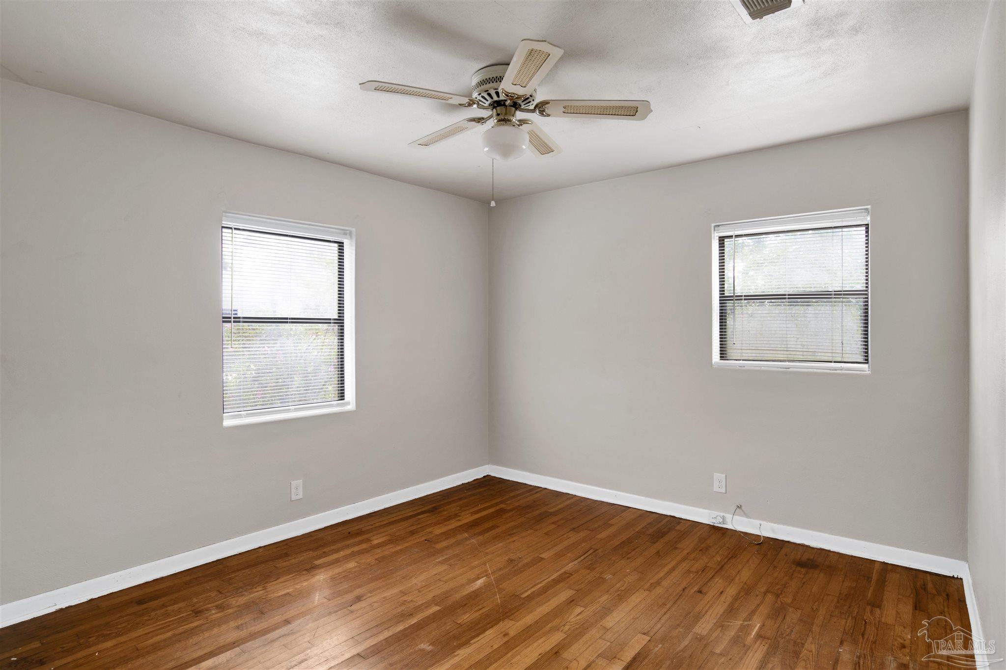 2802 West Gonzalez Street Pensacola, FL 32505 - Photo 16 of 24 wooden floor in an empty room with a window