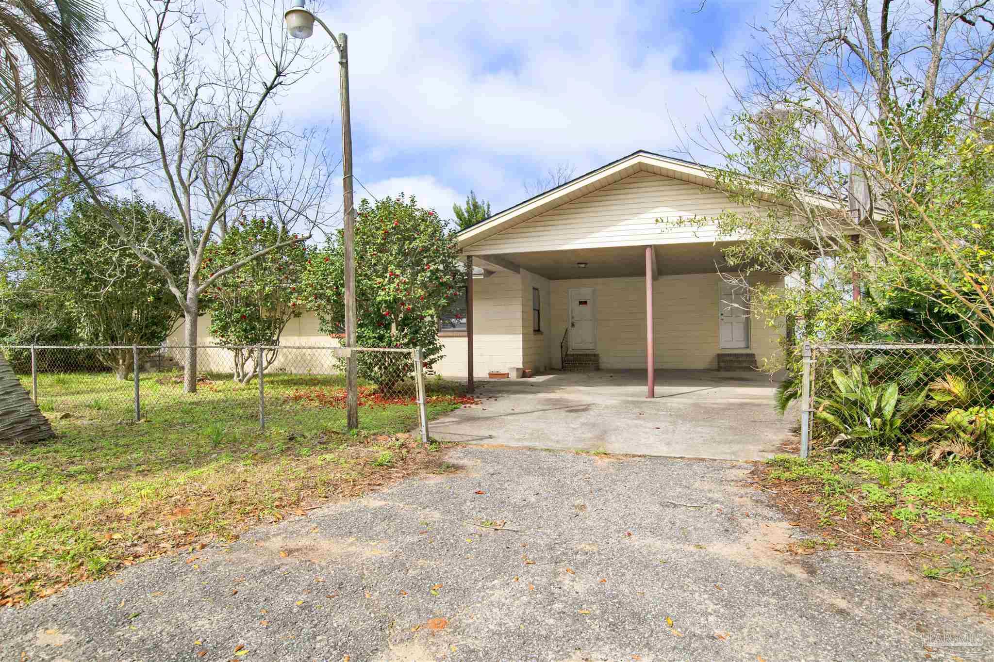 2802 West Gonzalez Street Pensacola, FL 32505 - Photo 2 of 24 a view of a house with backyard and trees