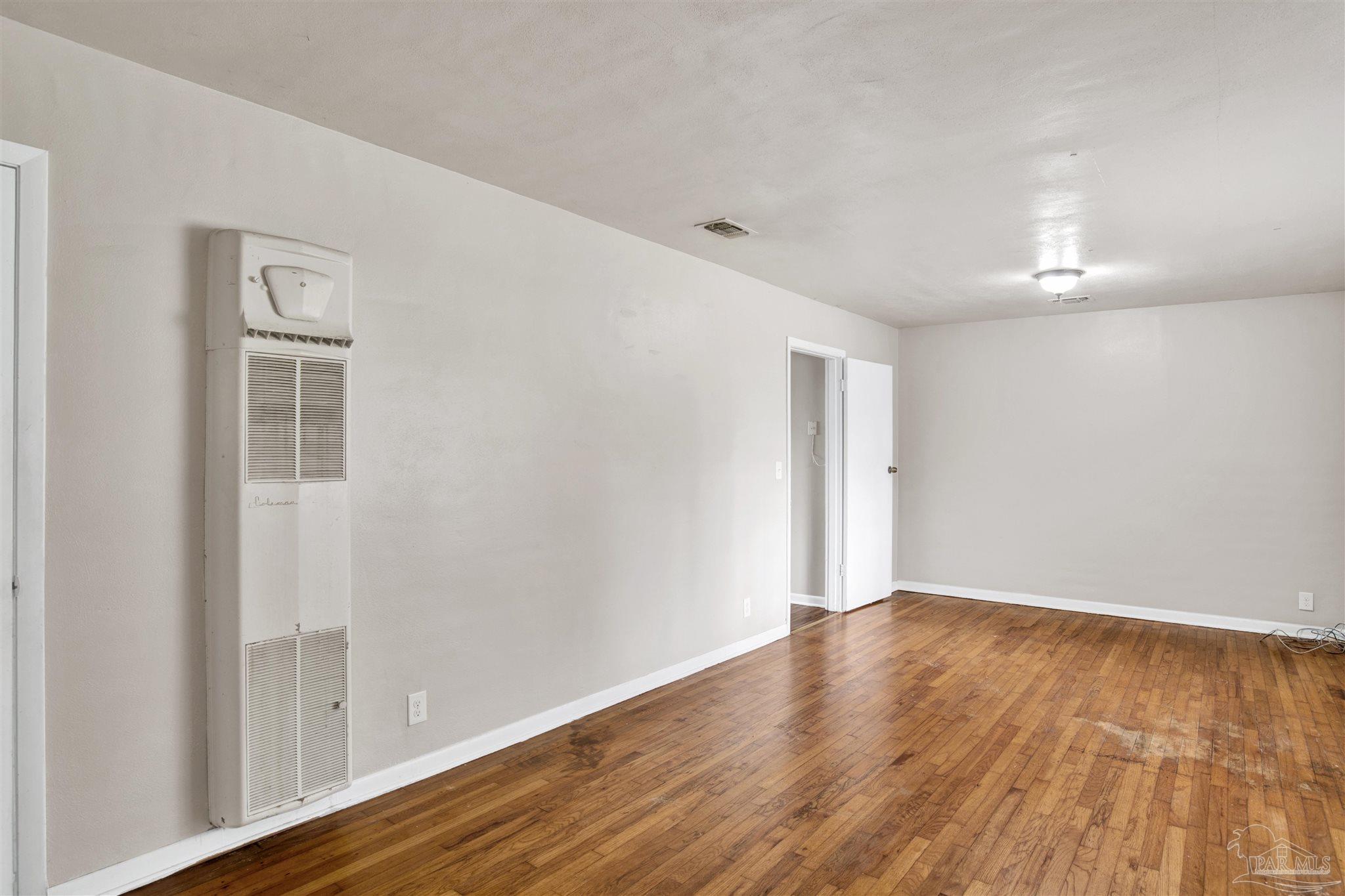 2802 West Gonzalez Street Pensacola, FL 32505 - Photo 4 of 24 a view of an empty room with wooden floor
