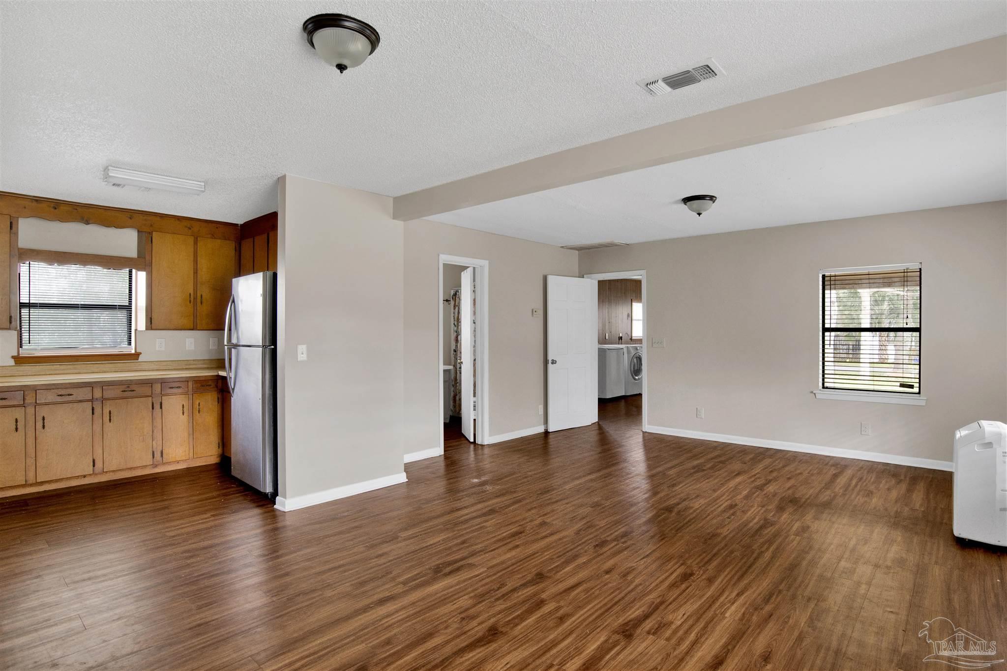 2802 West Gonzalez Street Pensacola, FL 32505 - Photo 10 of 24 a view of empty room with wooden floor and window