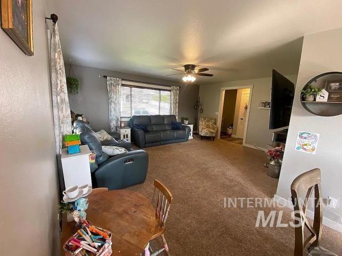 2113 Schaefer Drive Clarkston, WA 99403 - Photo 7 of 15 Living room featuring a ceiling fan and carpet