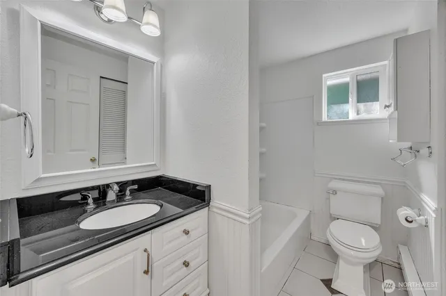 a bathroom with a sink toilet a mirror and vanity
