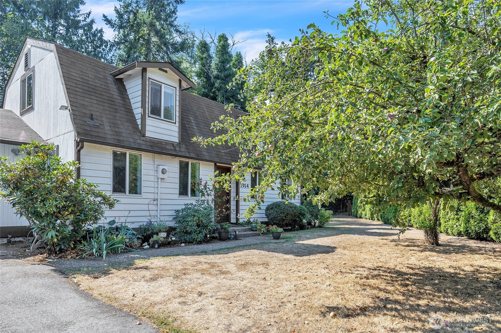 7914 242nd Street Southwest Edmonds, WA 98026 - Photo 38 of 38 a front view of a house with a yard and garage