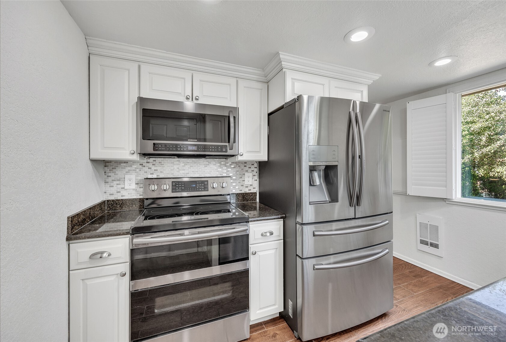 7914 242nd Street Southwest Edmonds, WA 98026 - Photo 5 of 38 a kitchen with cabinets stainless steel appliances and window