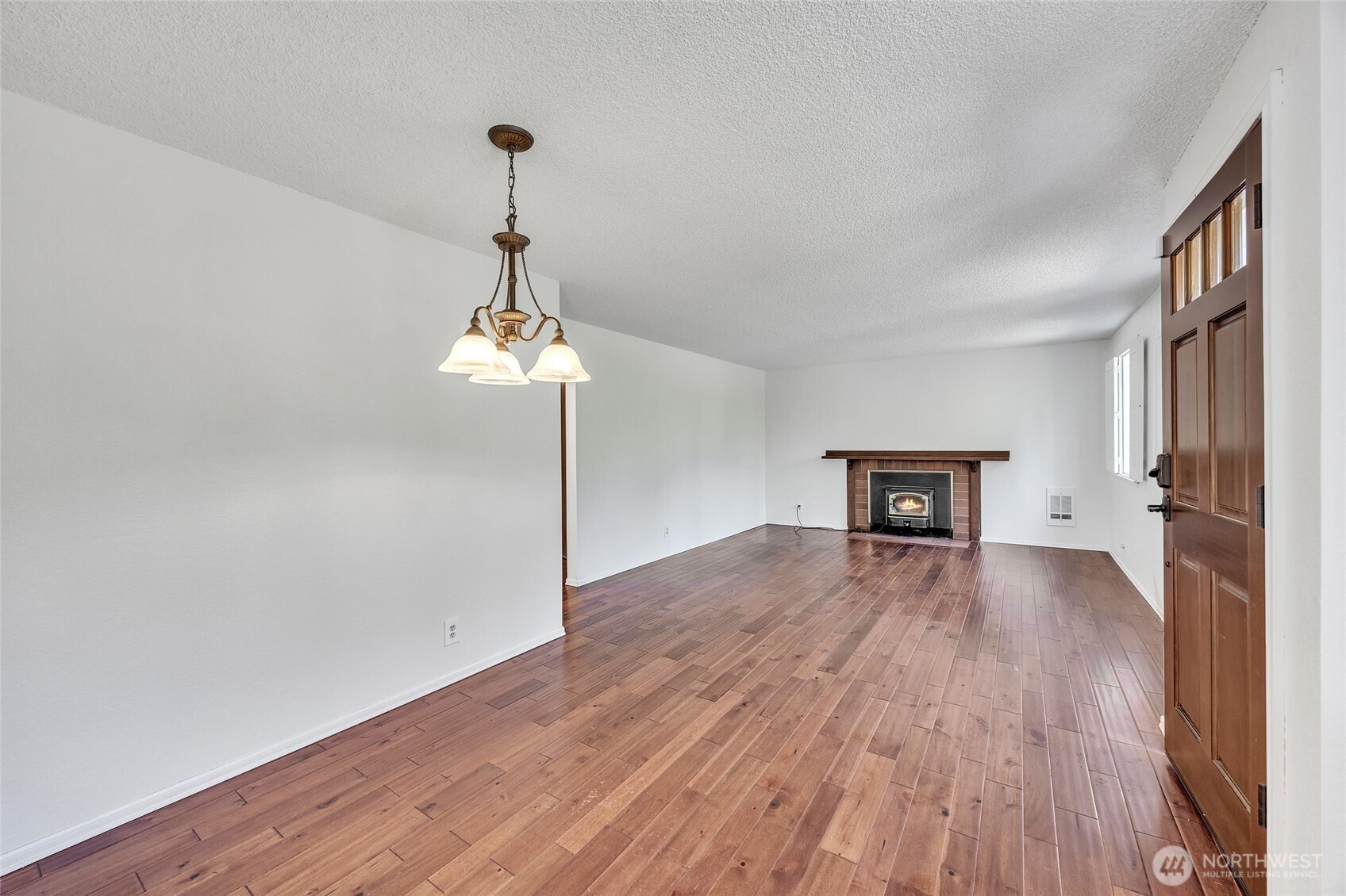 7914 242nd Street Southwest Edmonds, WA 98026 - Photo 8 of 38 a view of empty room with wooden floor and fireplace