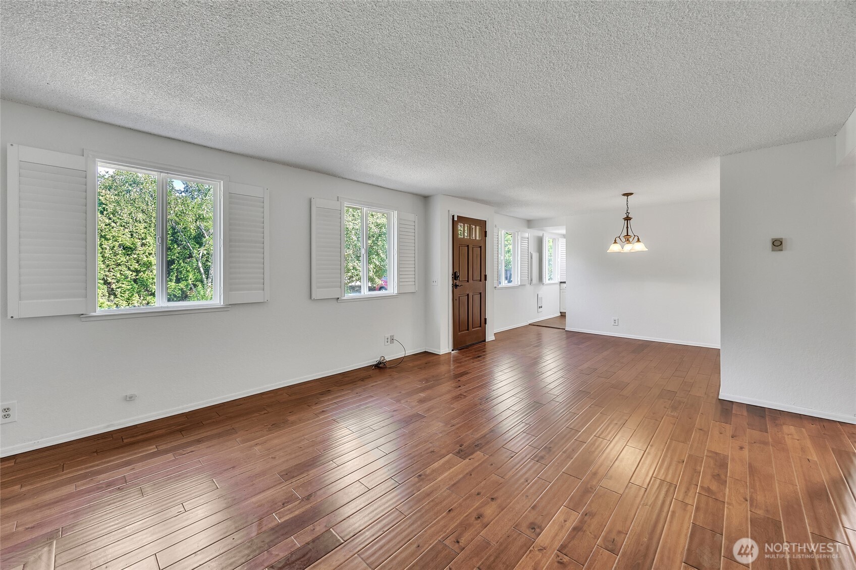 7914 242nd Street Southwest Edmonds, WA 98026 - Photo 9 of 38 an empty room with wooden floor and windows