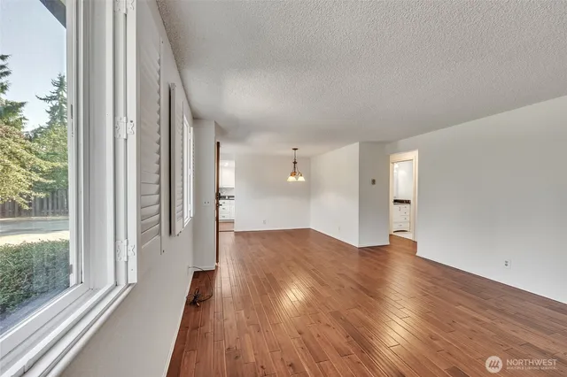 a view of wooden floor and windows in an empty room