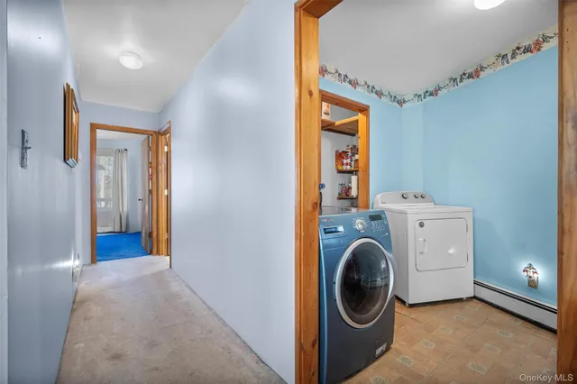 a view of a hallway with washer and dryer
