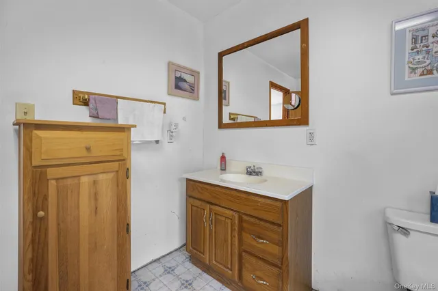 a bathroom with a sink a mirror and a toilet