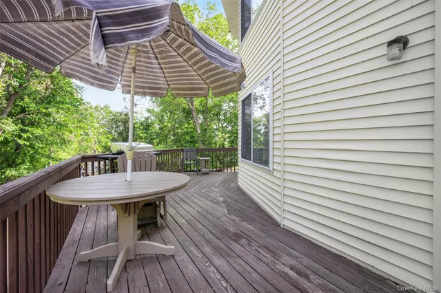 a view of a wooden chairs on the roof deck