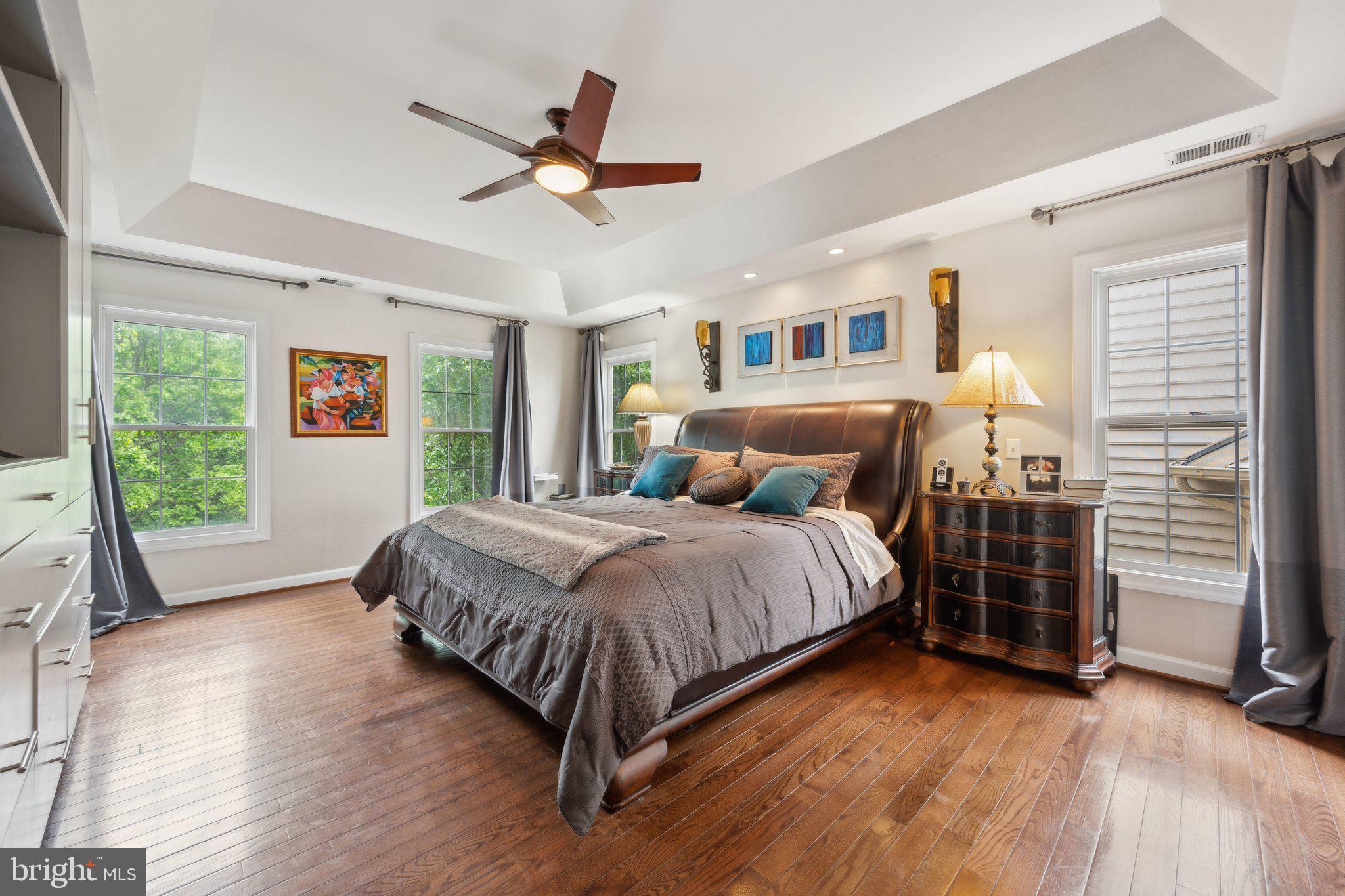 304 Thompson Dairy Way Rockville, MD 20850 - Photo 17 of 42 a bedroom with a large bed and a ceiling fan