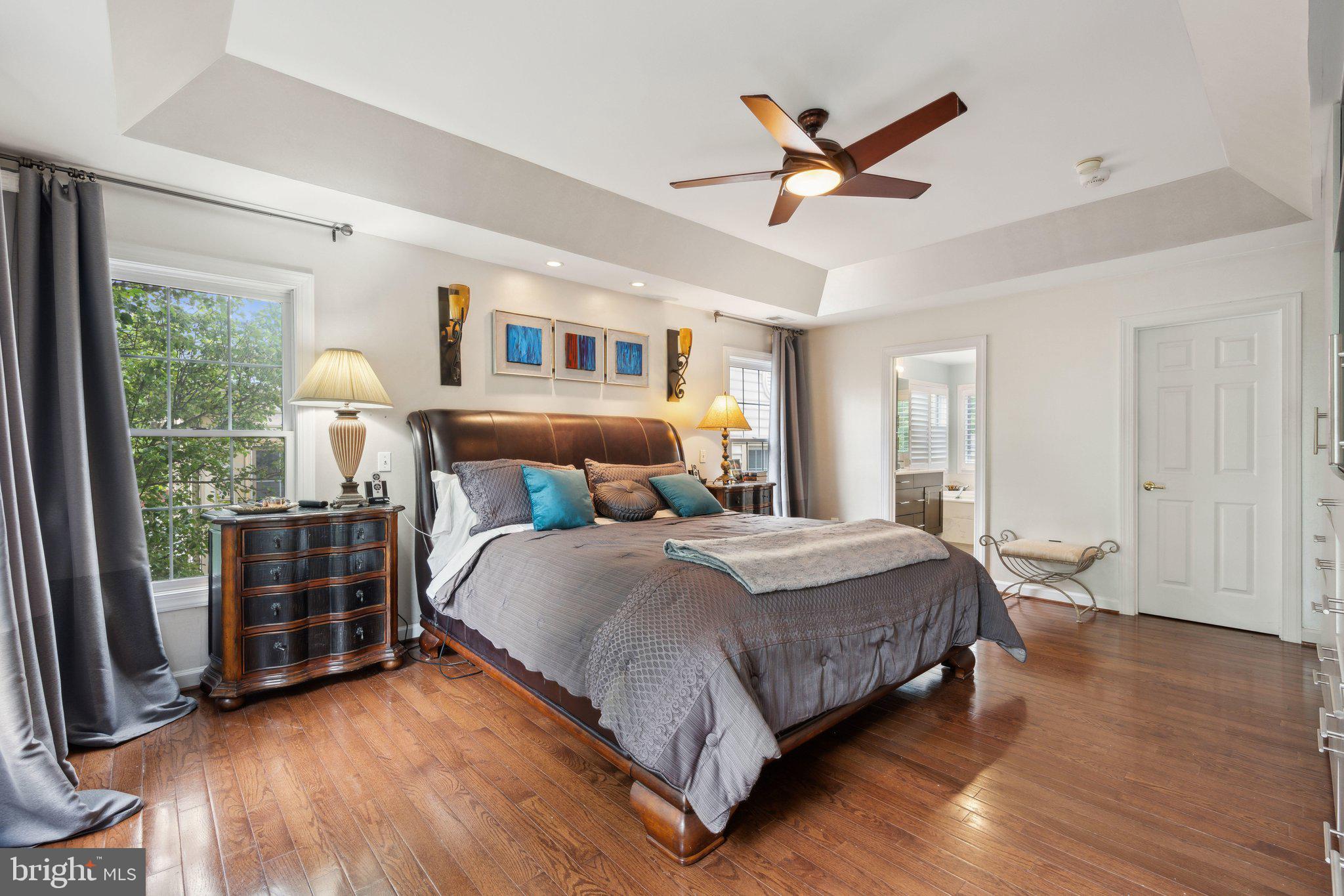 304 Thompson Dairy Way Rockville, MD 20850 - Photo 18 of 42 a bedroom with a large bed and a ceiling fan