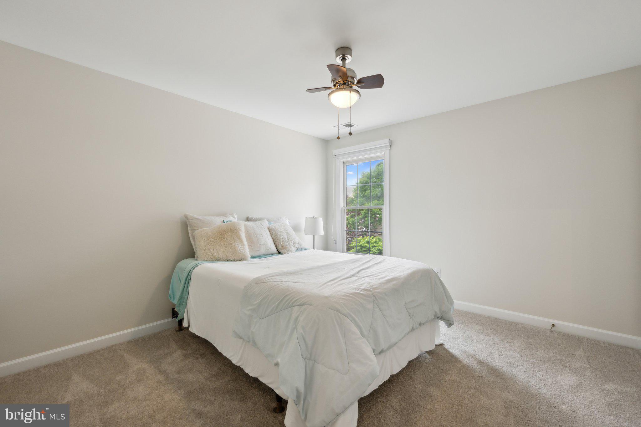 304 Thompson Dairy Way Rockville, MD 20850 - Photo 23 of 42 a bed sitting in a bedroom next to a window